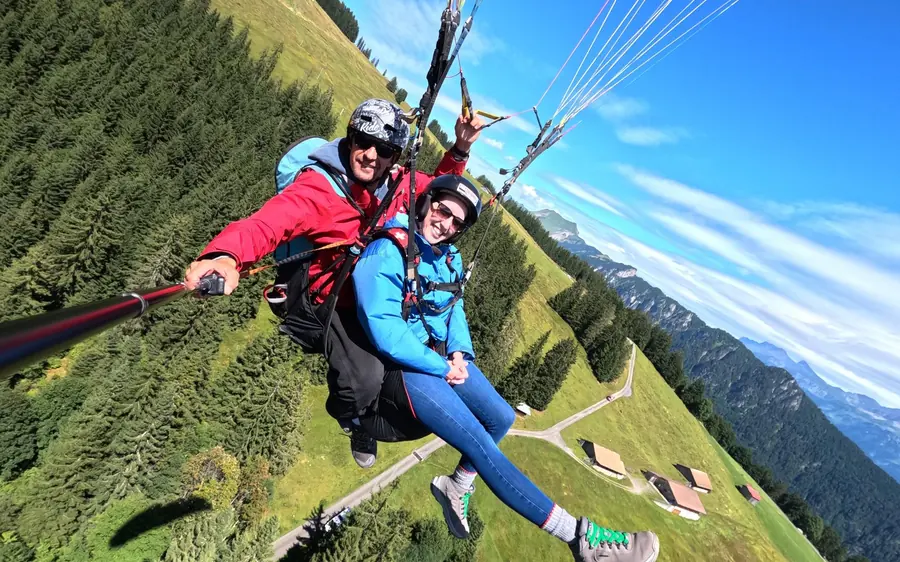 A tandem pair gliding above the town of Interlaken between two lakes